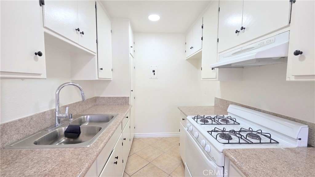3733 Durfee Avenue, Unit 7 El Monte, CA 91732 - Photo 13 of 14 a kitchen with granite countertop a sink stainless steel appliances and cabinets