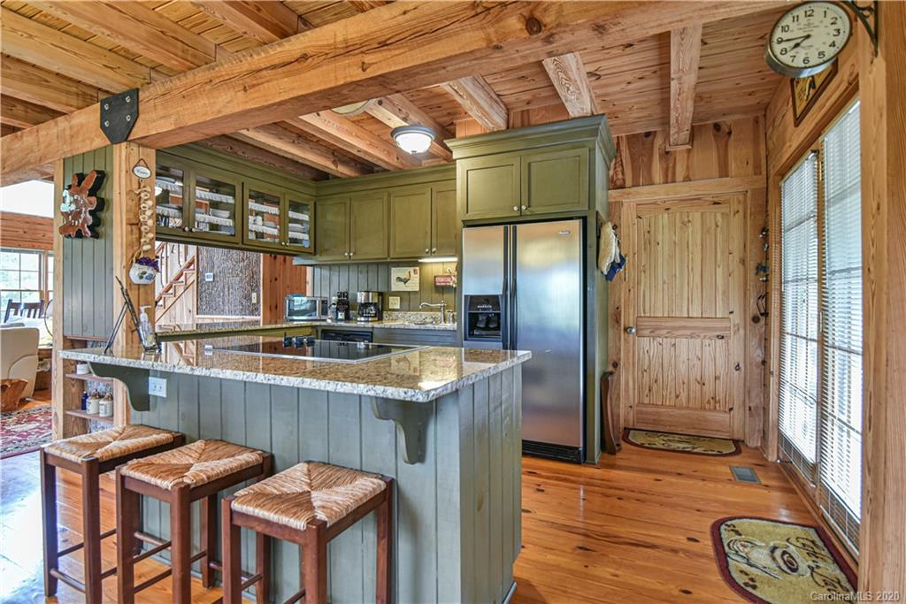 359 Dark Corner Road Rutherfordton, NC 28139 - Photo 18 of 36 a kitchen with stainless steel appliances granite countertop a table chairs and wooden floors