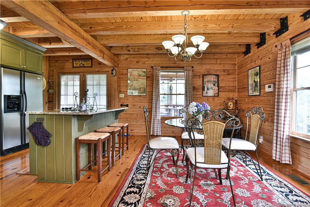 359 Dark Corner Road Rutherfordton, NC 28139 - Photo 19 of 36 a view of a dining room with furniture a chandelier and wooden floor