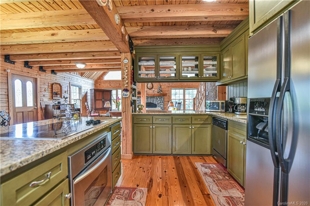 359 Dark Corner Road Rutherfordton, NC 28139 - Photo 21 of 36 a kitchen with stainless steel appliances granite countertop a sink and wooden cabinets