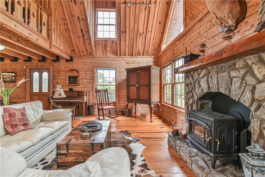 359 Dark Corner Road Rutherfordton, NC 28139 - Photo 23 of 36 a living room with furniture a fireplace and a large window
