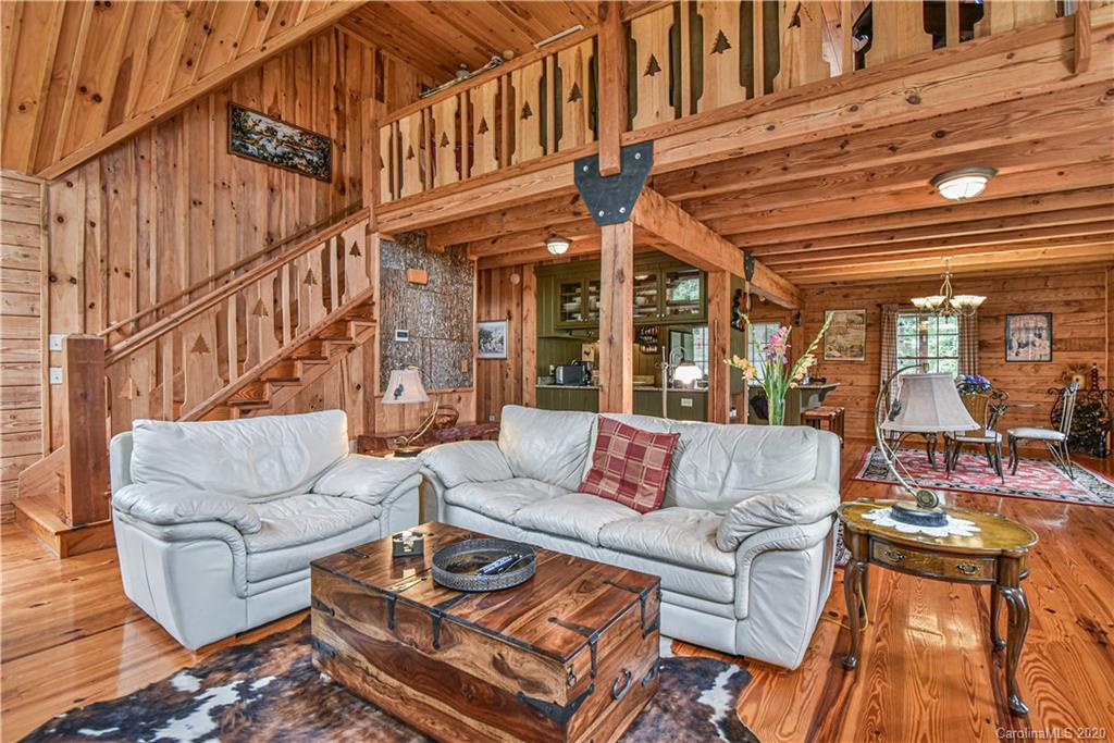 359 Dark Corner Road Rutherfordton, NC 28139 - Photo 26 of 36 a view of a patio with couches table and chairs with wooden floor