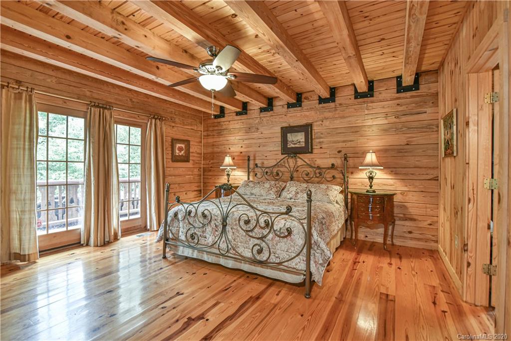 359 Dark Corner Road Rutherfordton, NC 28139 - Photo 27 of 36 a spacious bedroom with a bed and wooden floor