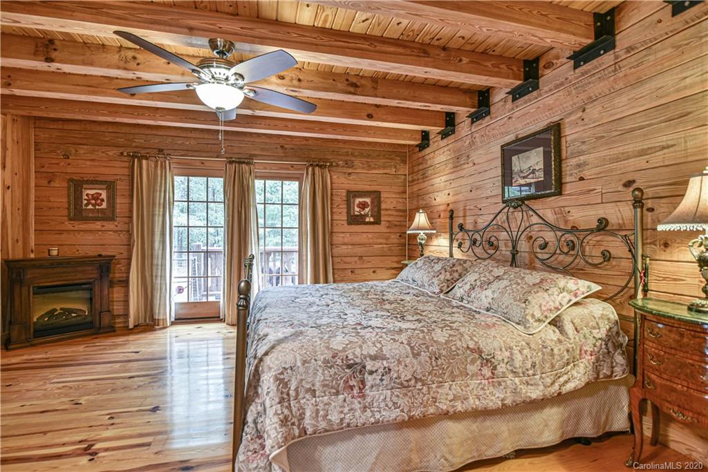 359 Dark Corner Road Rutherfordton, NC 28139 - Photo 28 of 36 a bed sitting in a spacious bedroom next to a balcony