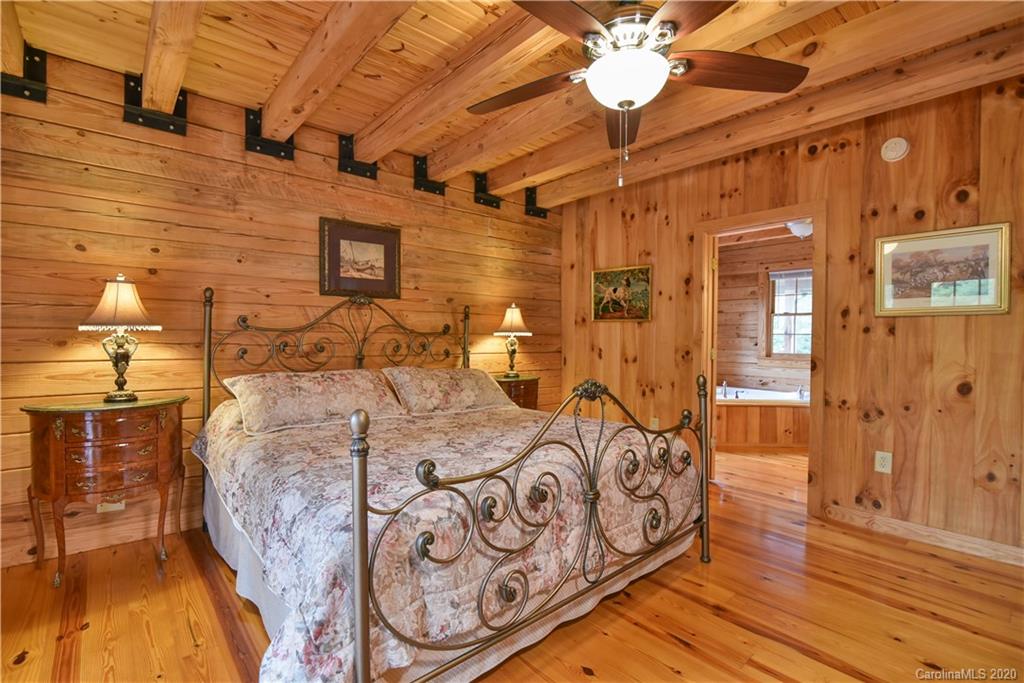 359 Dark Corner Road Rutherfordton, NC 28139 - Photo 29 of 36 a bedroom with a bed and a chandelier