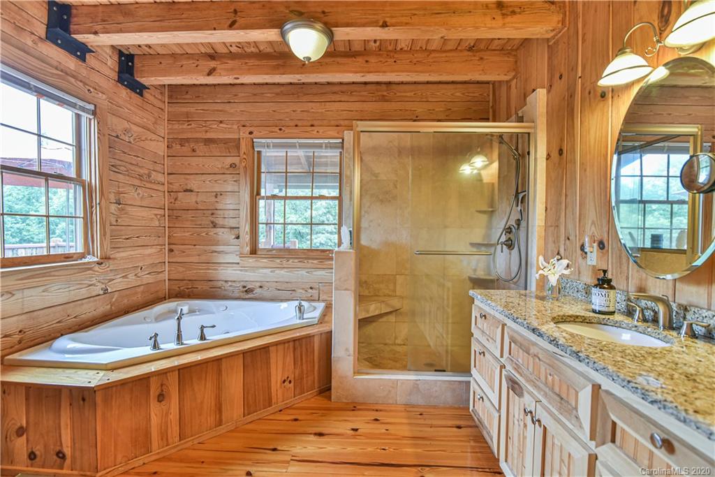 359 Dark Corner Road Rutherfordton, NC 28139 - Photo 30 of 36 a bathroom with a granite countertop sink mirror vanity and bathtub