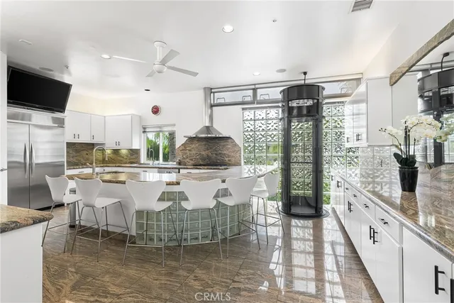 a large kitchen with a table chairs and a sink