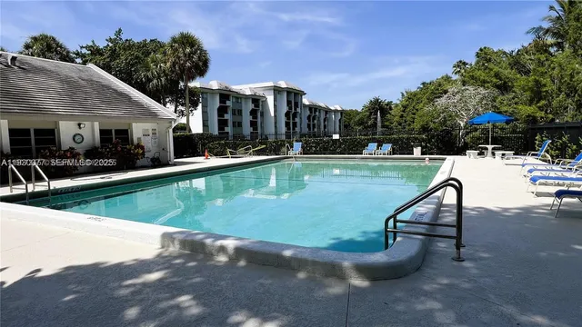 a view of a swimming pool and lounge chairs