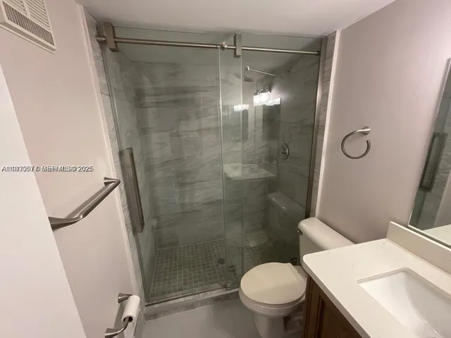 a bathroom with a shower and a toilet