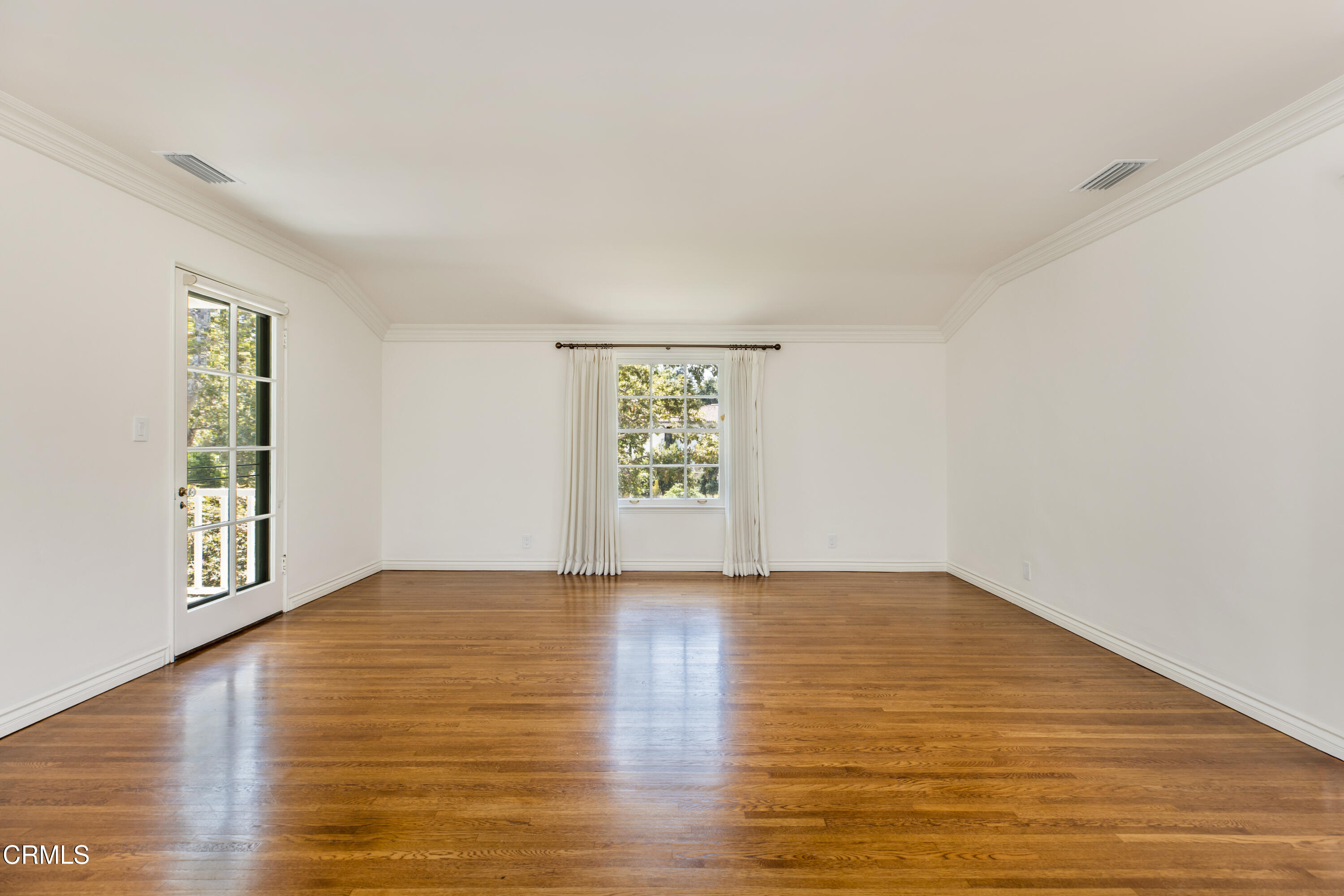 1184 Arden Road Pasadena, CA 91106 - Photo 26 of 62 a view of an empty room with window and wooden floor