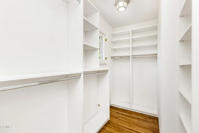 a backyard of a house with plants and large trees