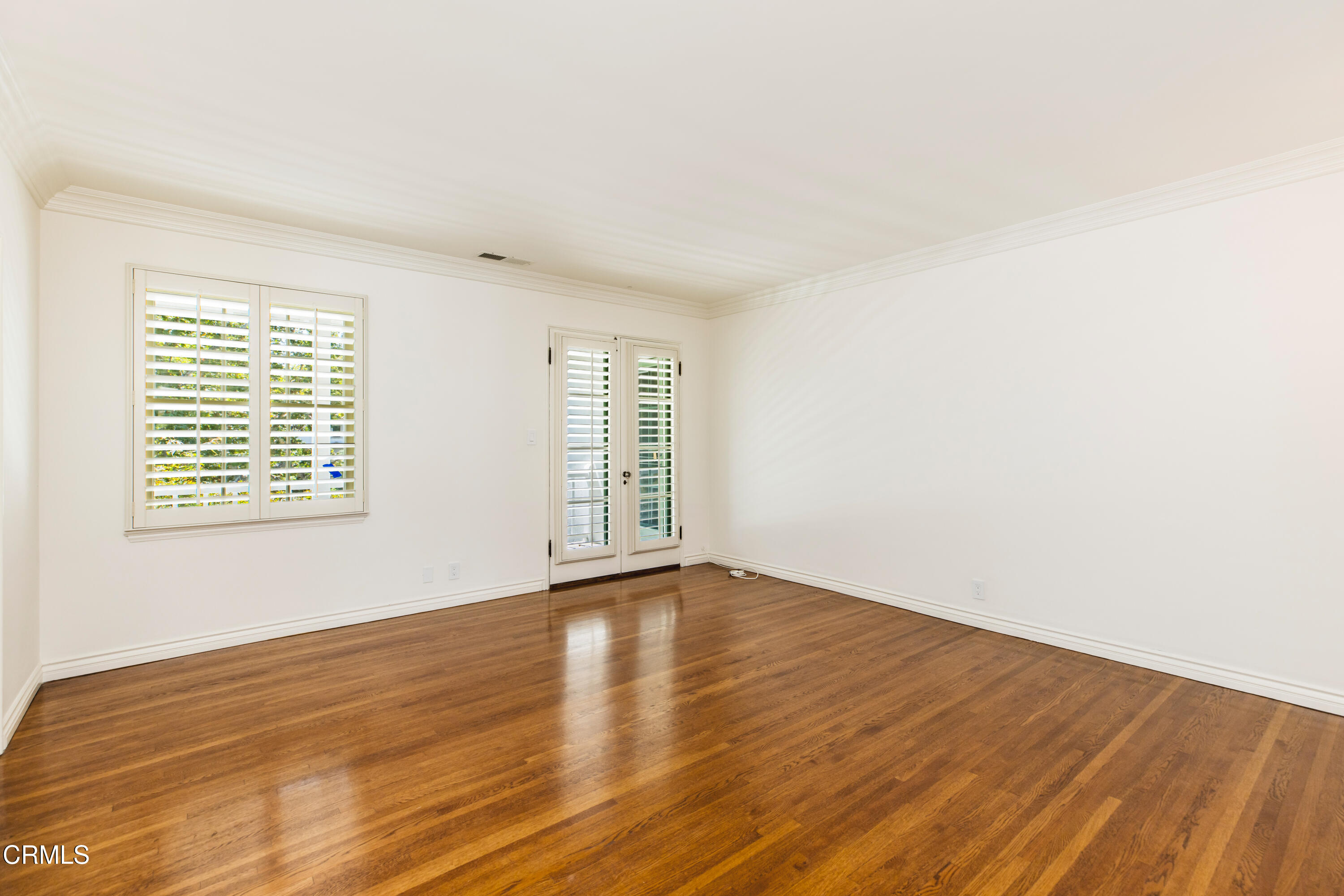 1184 Arden Road Pasadena, CA 91106 - Photo 39 of 62 an empty room with wooden floor and windows