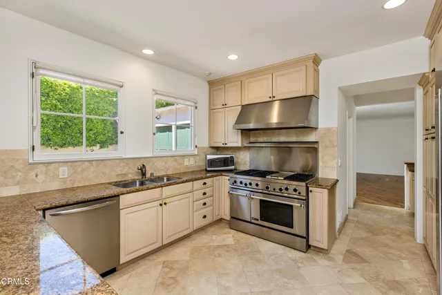 a kitchen that has a sink and a stove in it