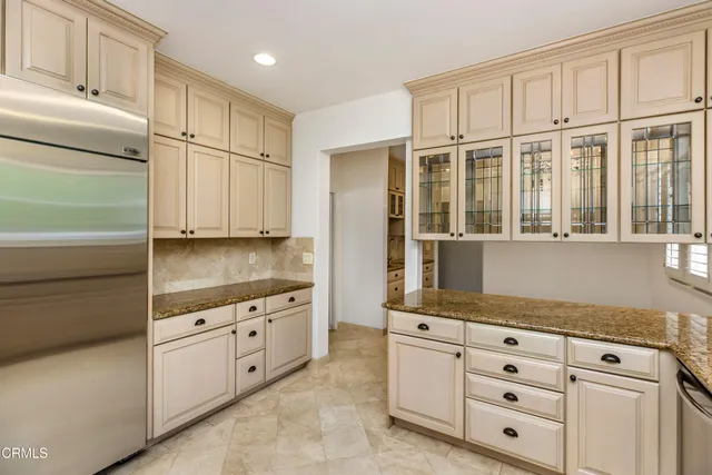 a spacious bathroom with a granite countertop sink and a mirror