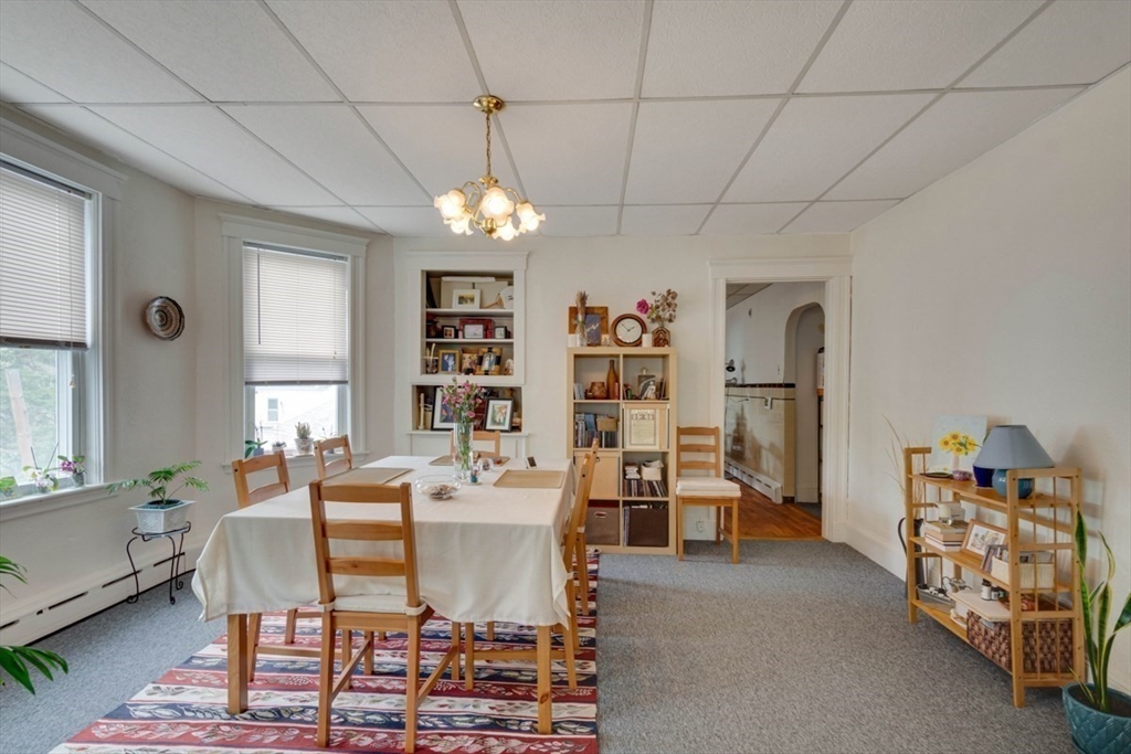 45 Jackson Road Somerville, MA 02145 - Photo 25 of 27 a dining room with furniture a chandelier and window
