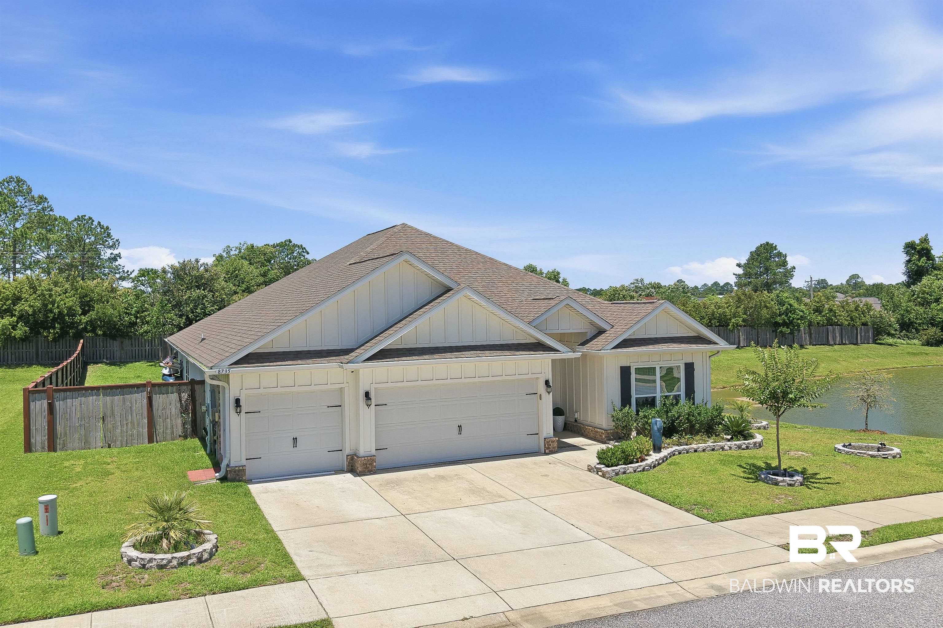 8735 Bronze Lane Foley, AL 36535 - Photo 51 of 58 Exterior featuring light-colored vertical siding and a dual garage