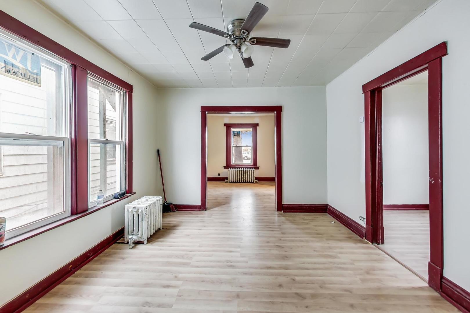 3441 Chicago Road Steger, IL 60475 - Photo 11 of 31 a view of a hallway with wooden floor and a window