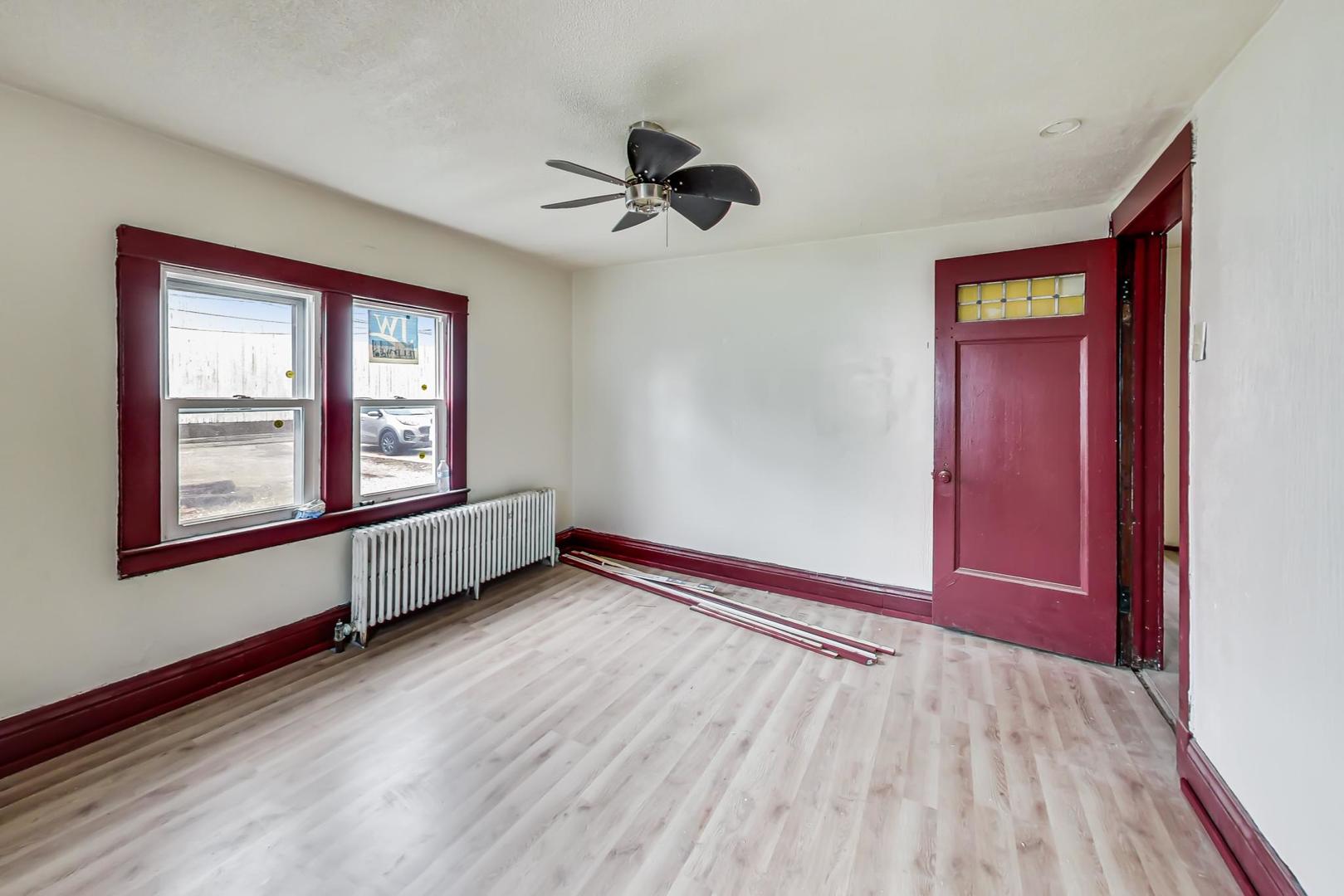 3441 Chicago Road Steger, IL 60475 - Photo 17 of 31 a view of an empty room with a window and wooden floor
