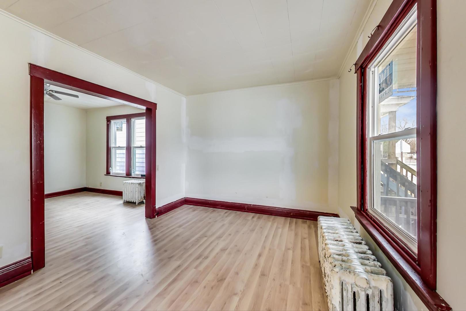 3441 Chicago Road Steger, IL 60475 - Photo 7 of 31 a view of an empty room with glass door with wooden floor and windows