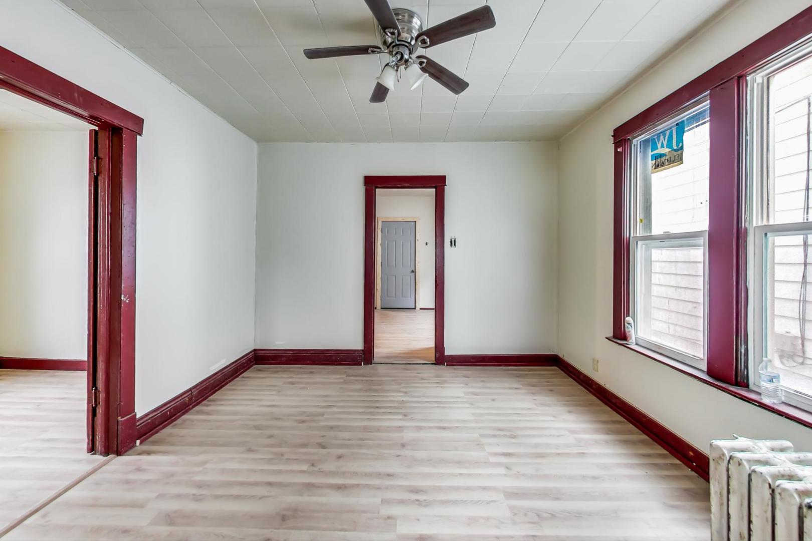 3441 Chicago Road Steger, IL 60475 - Photo 9 of 31 a view of an empty room with a window and wooden floor