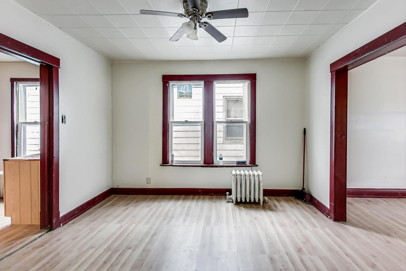 3441 Chicago Road Steger, IL 60475 - Photo 10 of 31 an empty room with wooden floor and windows