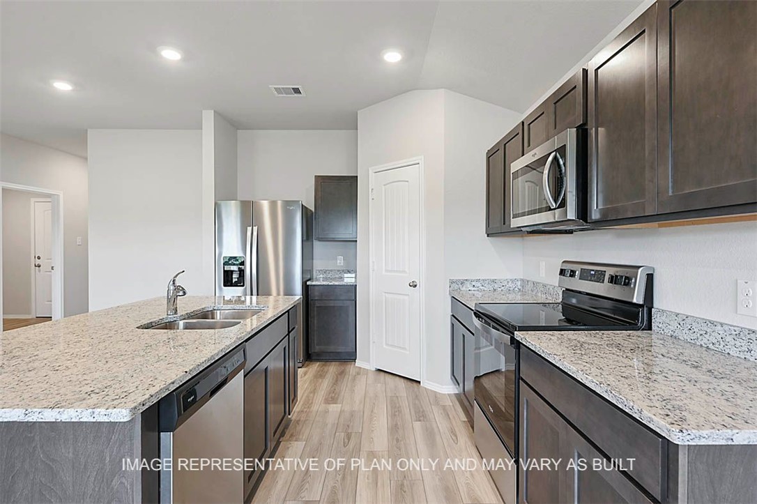 5417-bear Run 5417-bear Run Bryan, TX 77807 - Photo 3 of 18 a kitchen with stainless steel appliances granite countertop a sink stove and refrigerator