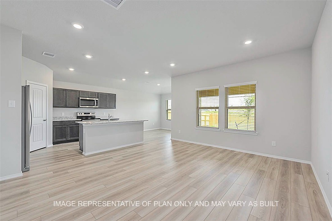5417-bear Run 5417-bear Run Bryan, TX 77807 - Photo 4 of 18 a large kitchen with kitchen island a sink dishwasher a stove and a refrigerator with wooden floor