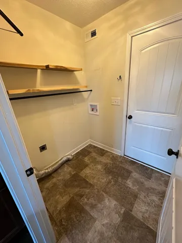 en empty room with windows and ceiling fan