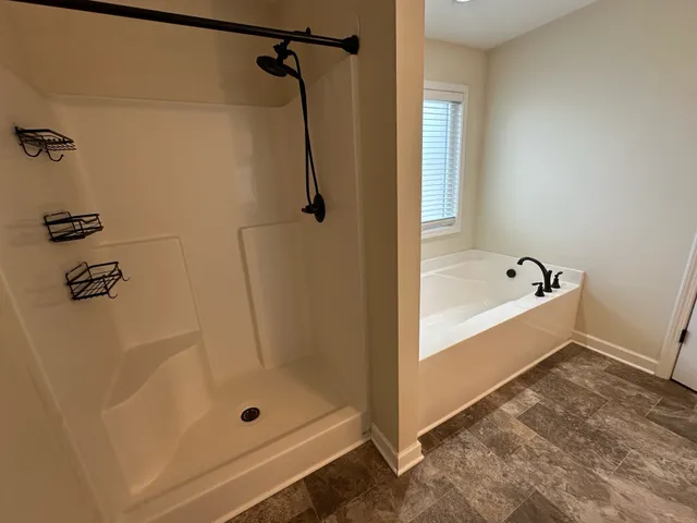 a living room with kitchen island granite countertop wooden floor and a large window