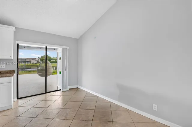 a view of an empty room with glass door