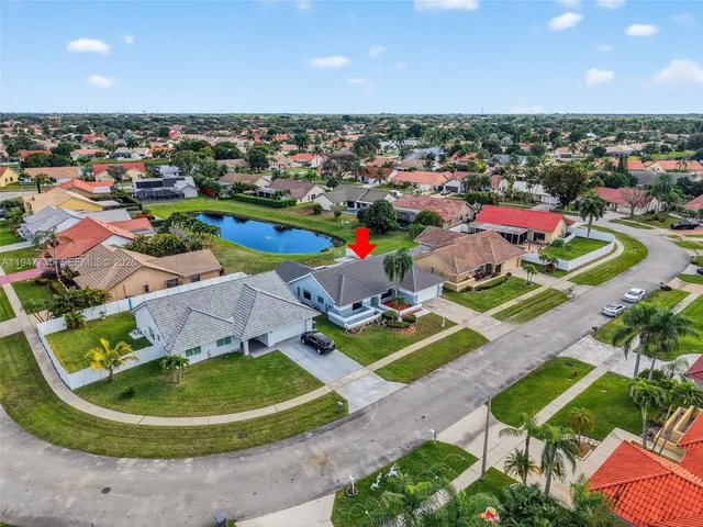 an aerial view of a house with a swimming pool yard and outdoor seating