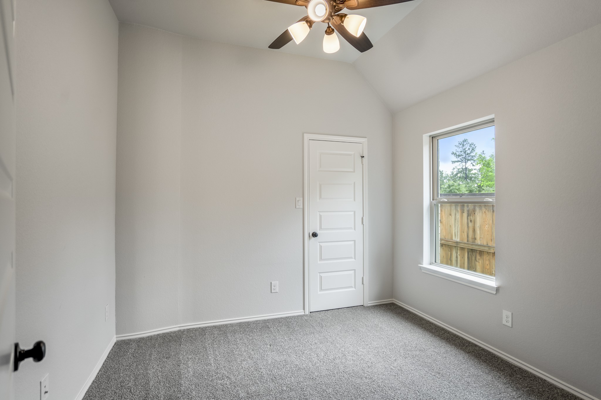 334 Topper Pines Drive Montgomery, TX 77316 - Photo 29 of 49 Continuing past the full bath, the hallway ends at the last secondary bedroom, where carpet, a ceiling fan, and natural light keep the room simple and comfortable.