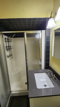 a bathroom with a tub a sink and a mirror