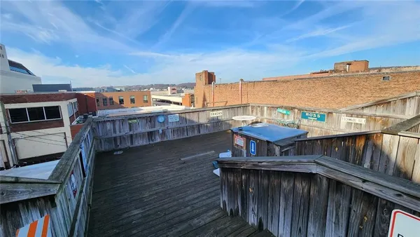 a view of a roof deck with wooden fence