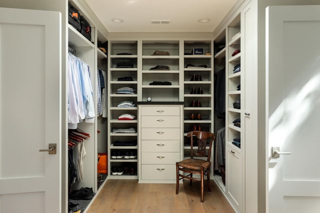 a view of walk in closet with clothes and shoes