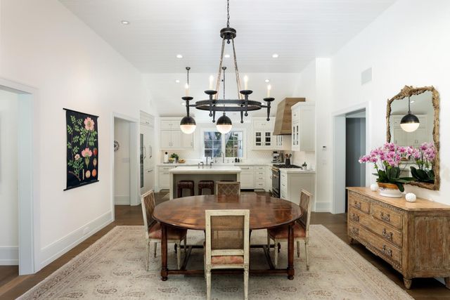 a view of a dining room with furniture and chandelier