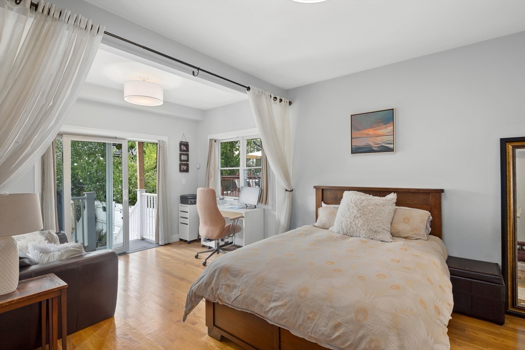 299 Sumner Street, Unit 1 Boston, MA 02128 - Photo 11 of 23 a bedroom with a bed and wooden floor