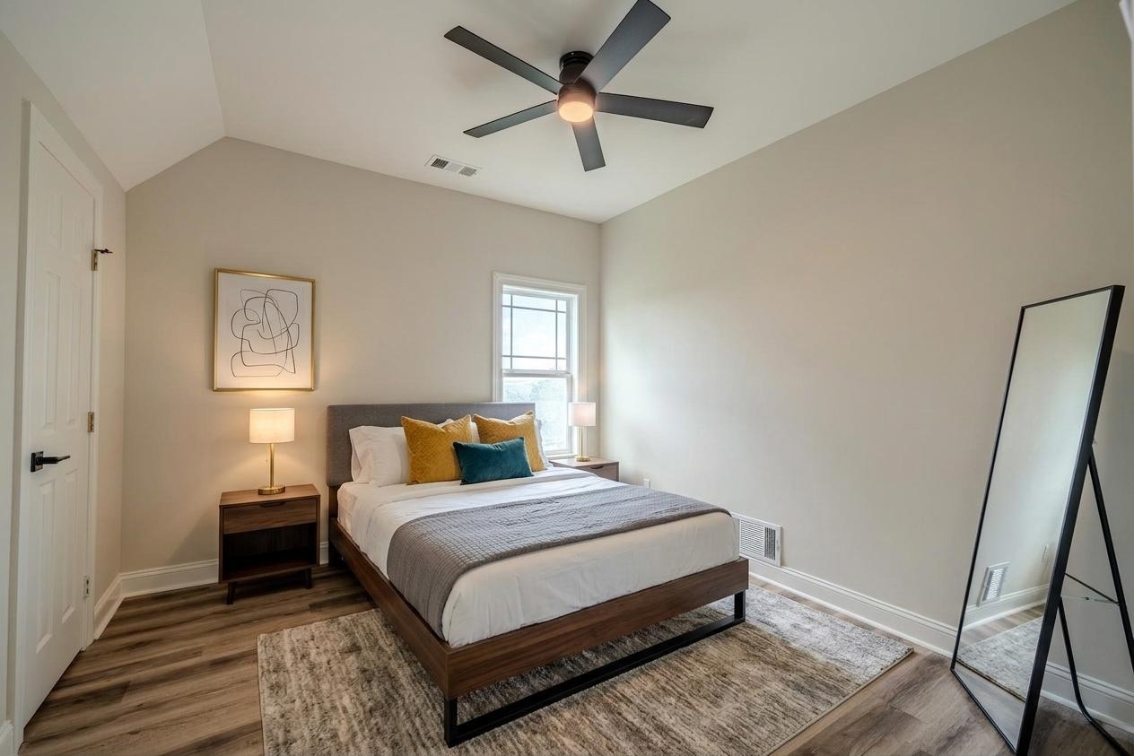 851 Rivers Edge Drive Bath Springs, TN 38311 - Photo 5 of 39 Vaulted ceiling bedroom featuring wood-finish flooring, a contemporary ceiling fan, and a multi-pane window