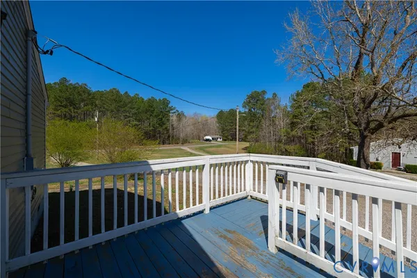 a view of a balcony with wooden fence and floor
