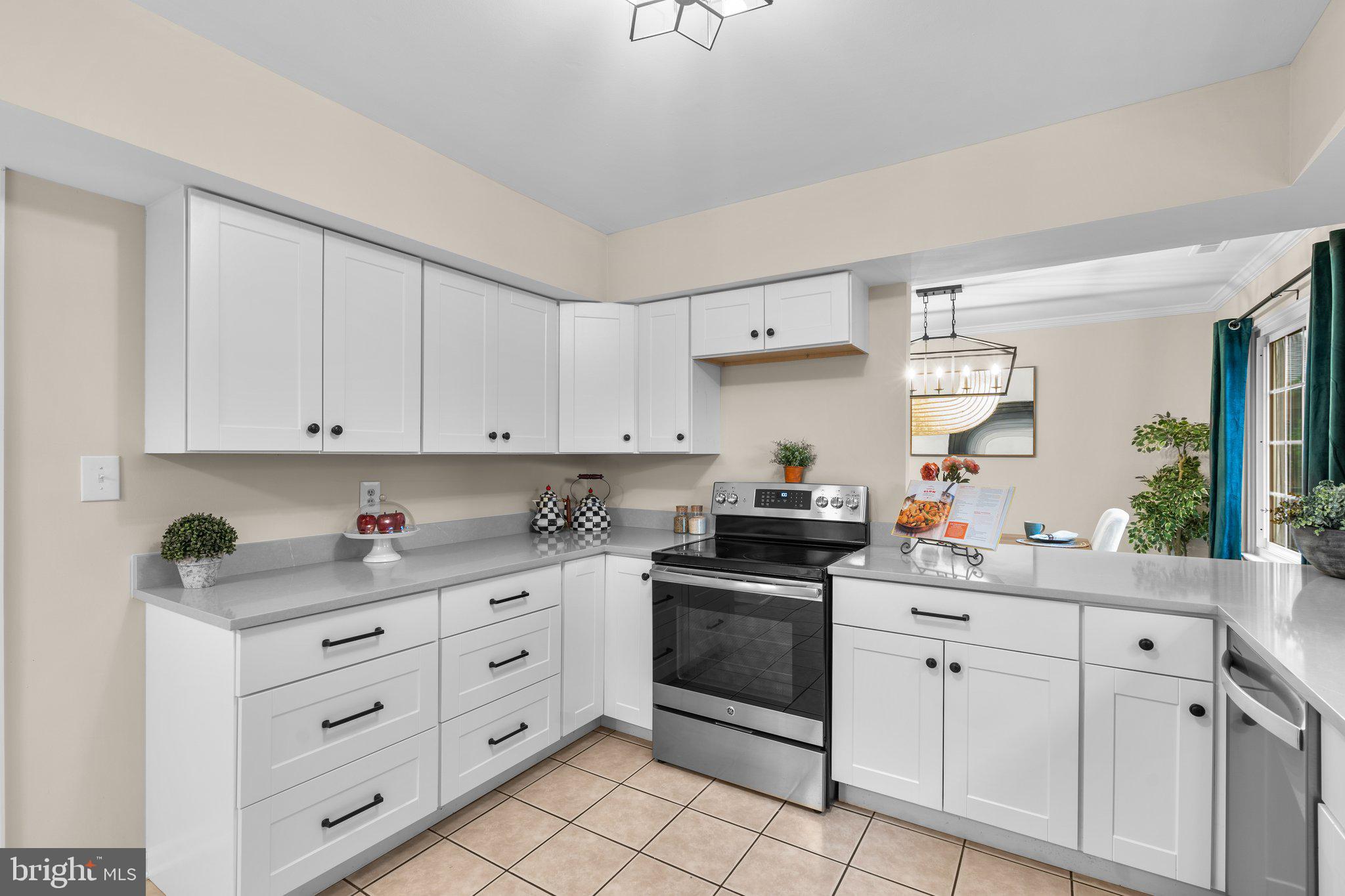 7206 Beverly Park Drive Springfield, VA 22150 - Photo 16 of 47 a kitchen with white cabinets and white appliances