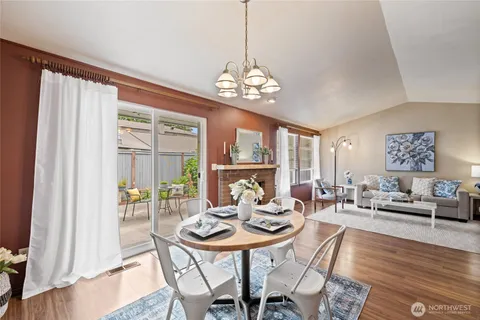 a view of a dining room with furniture wooden floor and a chandelier