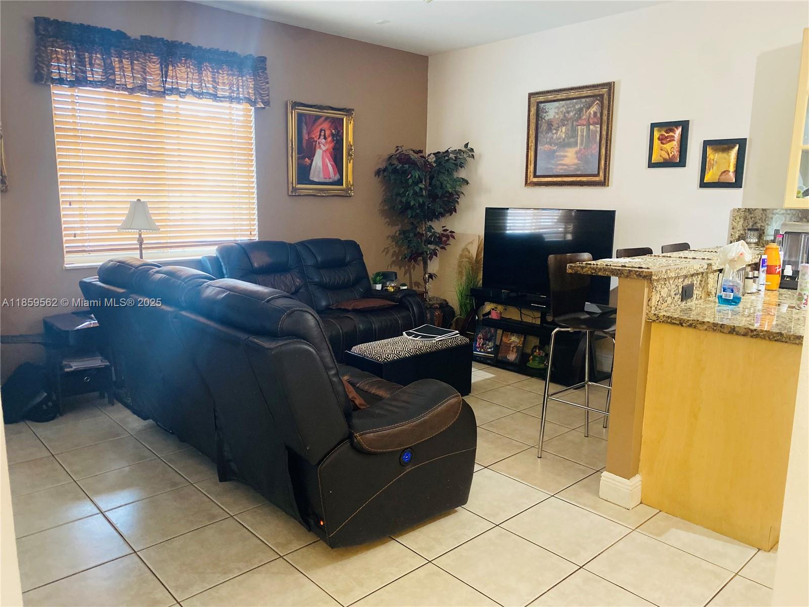 7760 Northwest 163rd Street Miami Lakes, FL 33016 - Photo 21 of 68 a living room with furniture and a flat screen tv