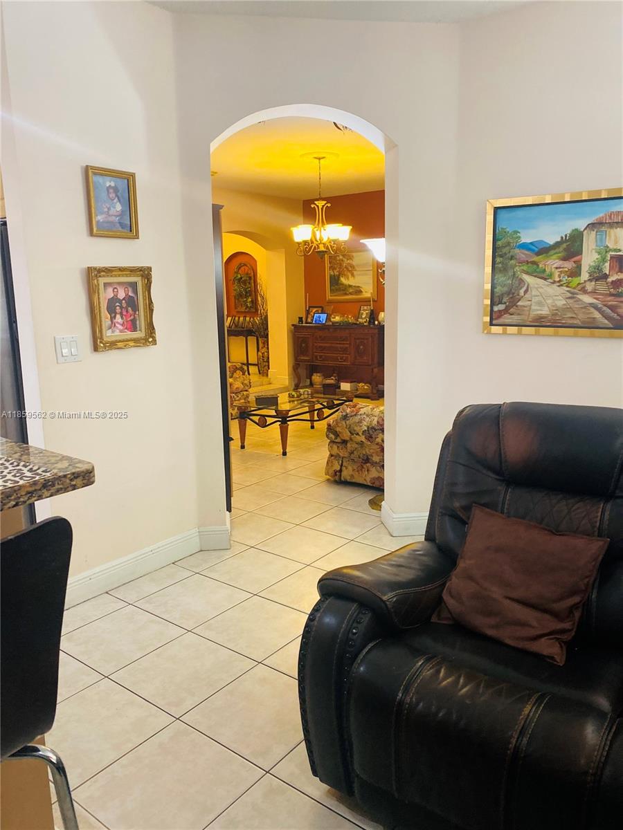 7760 Northwest 163rd Street Miami Lakes, FL 33016 - Photo 24 of 68 a living room with furniture and a painting on the wall