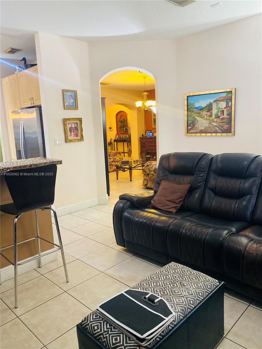 7760 Northwest 163rd Street Miami Lakes, FL 33016 - Photo 25 of 68 a living room with a couch and a table