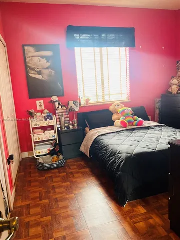 a bedroom with a bed and cabinets