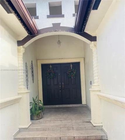 a view of entryway with a door and a potted plant