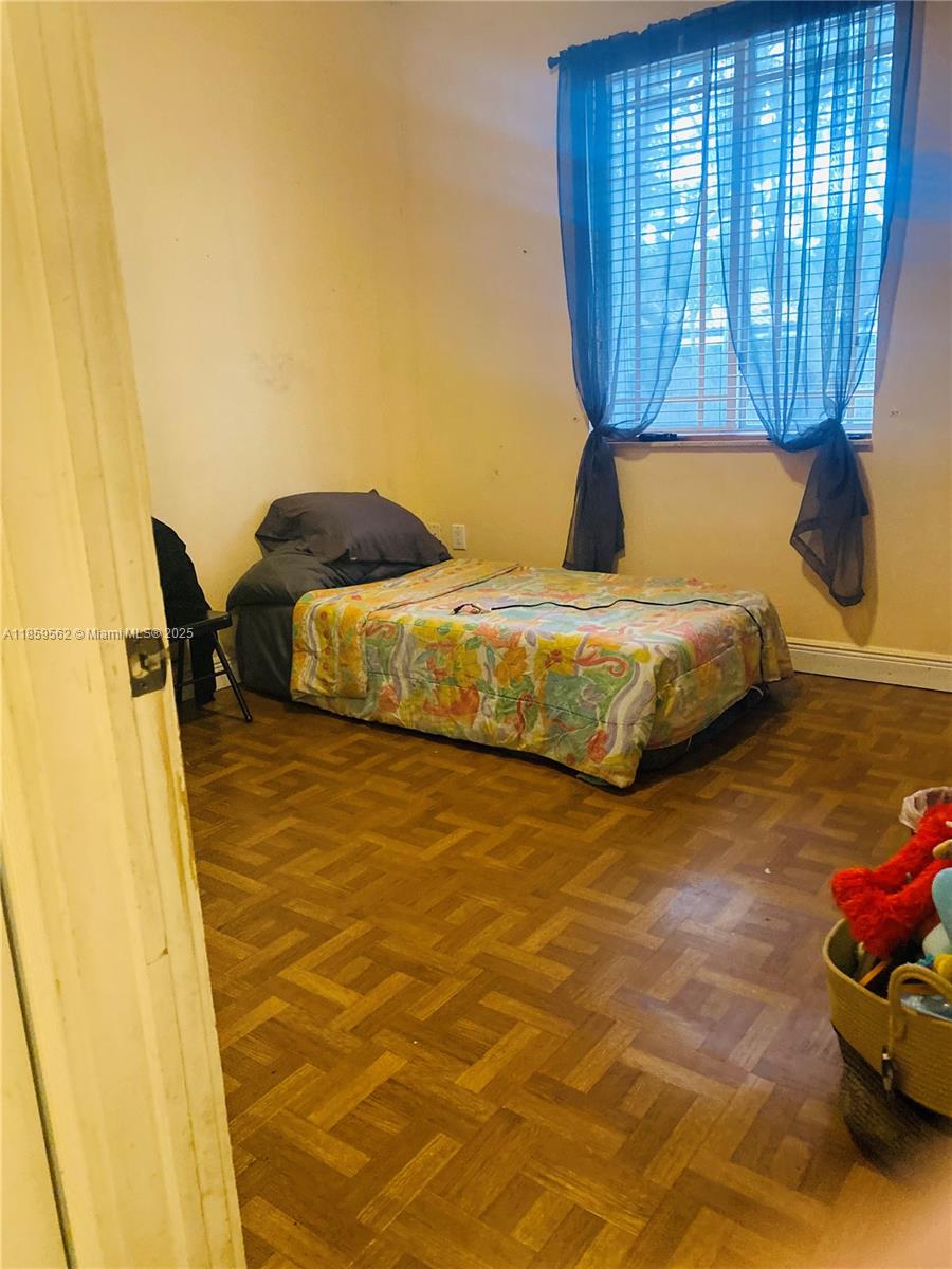 7760 Northwest 163rd Street Miami Lakes, FL 33016 - Photo 33 of 68 a bedroom with a bed and dresser