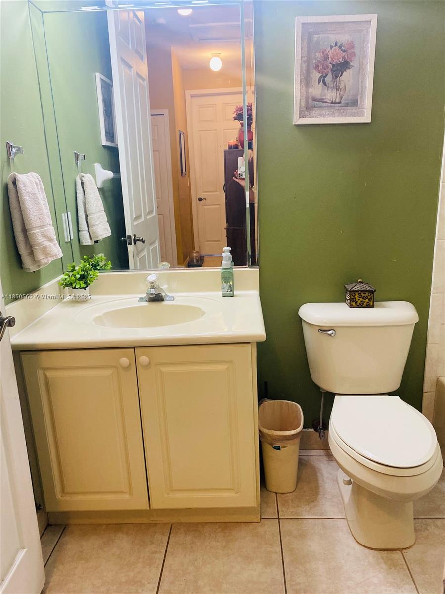 7760 Northwest 163rd Street Miami Lakes, FL 33016 - Photo 36 of 68 a bathroom with a toilet sink and mirror