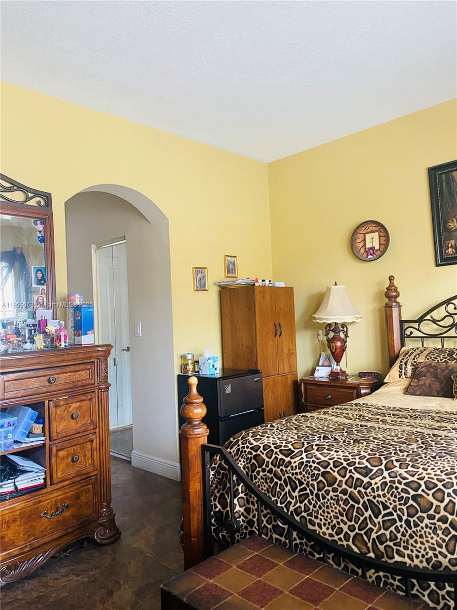 7760 Northwest 163rd Street Miami Lakes, FL 33016 - Photo 40 of 68 a bedroom with a bed and cabinets