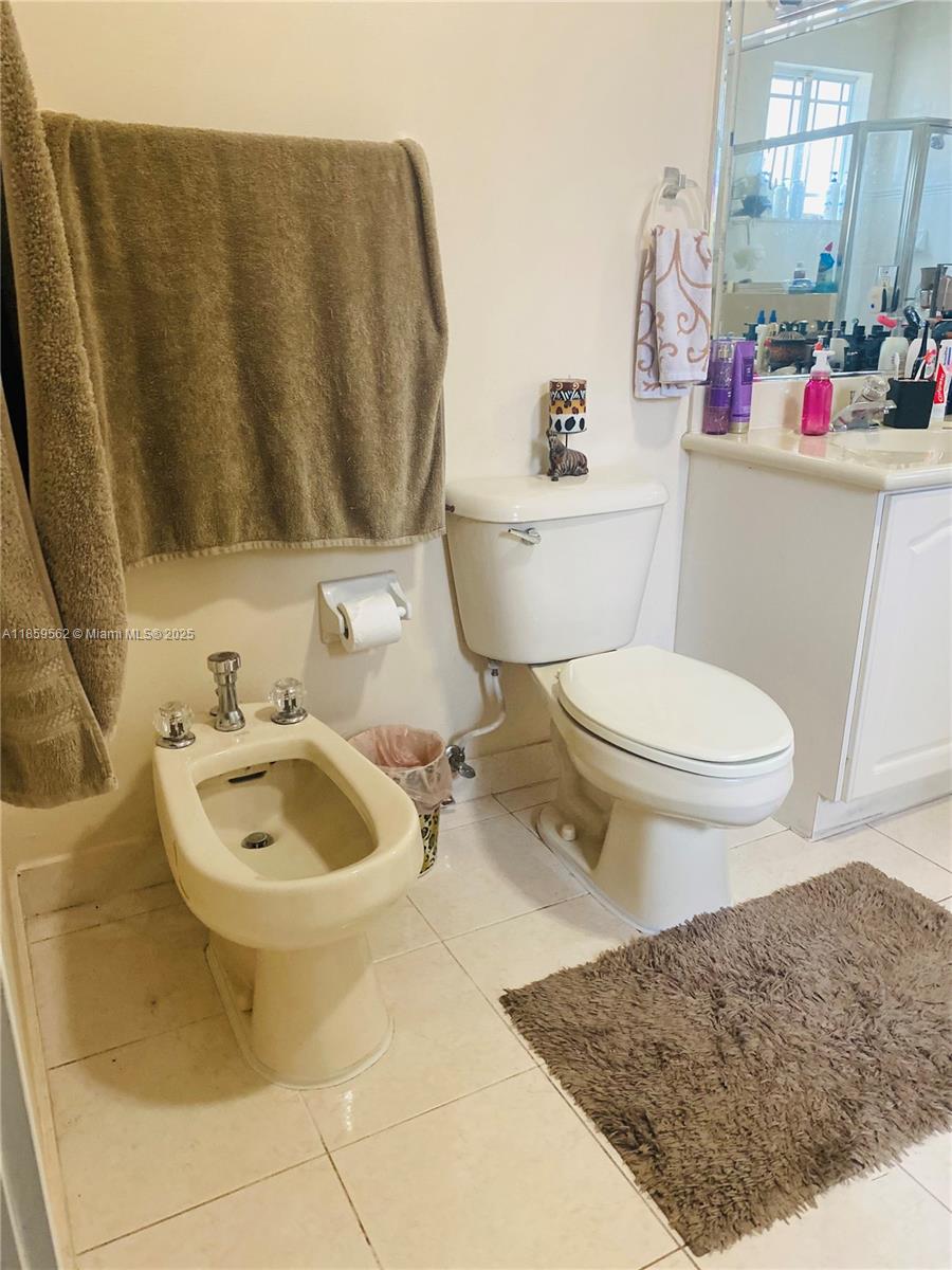 7760 Northwest 163rd Street Miami Lakes, FL 33016 - Photo 47 of 68 a bathroom with a sink a toilet and a mirror
